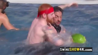 A powered group of swingers is having fun carrying-on naked in the water.